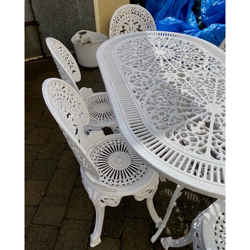 8 - A DECORATIVE CAST IRON GARDEN TABLE WITH CHAIRS, oval table with undertier joined by scrolling feet,... 