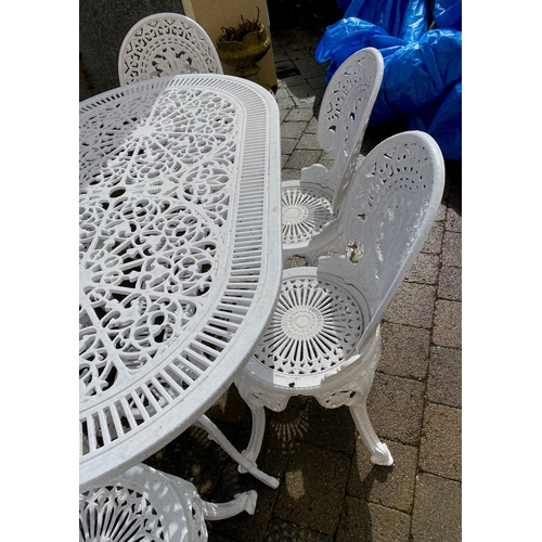 8 - A DECORATIVE CAST IRON GARDEN TABLE WITH CHAIRS, oval table with undertier joined by scrolling feet,... 