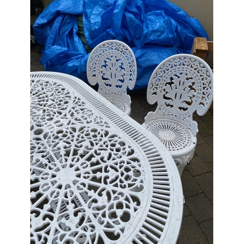 8 - A DECORATIVE CAST IRON GARDEN TABLE WITH CHAIRS, oval table with undertier joined by scrolling feet,... 