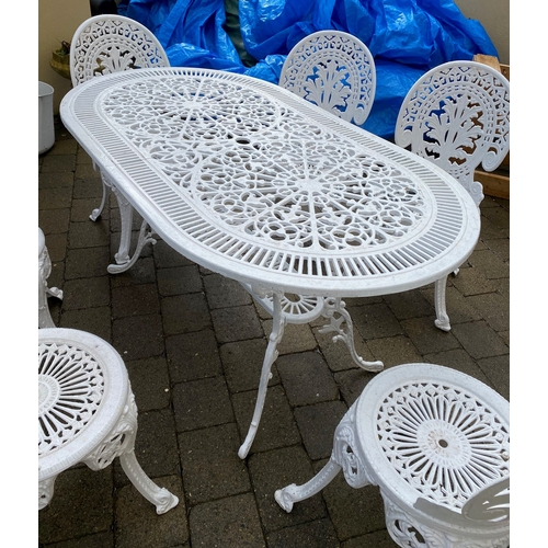 8 - A DECORATIVE CAST IRON GARDEN TABLE WITH CHAIRS, oval table with undertier joined by scrolling feet,... 