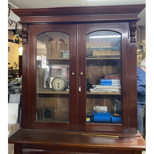 120 - A VICTORIAN MAHOGANY GLAZED BOOKCASE, with cornice above arched glass panelled doors, with carving t... 