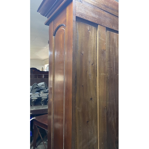 120 - A VICTORIAN MAHOGANY GLAZED BOOKCASE, with cornice above arched glass panelled doors, with carving t... 