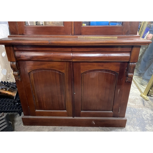 120 - A VICTORIAN MAHOGANY GLAZED BOOKCASE, with cornice above arched glass panelled doors, with carving t... 