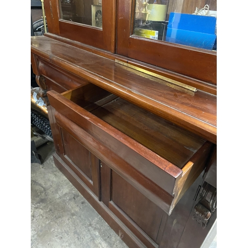 120 - A VICTORIAN MAHOGANY GLAZED BOOKCASE, with cornice above arched glass panelled doors, with carving t... 