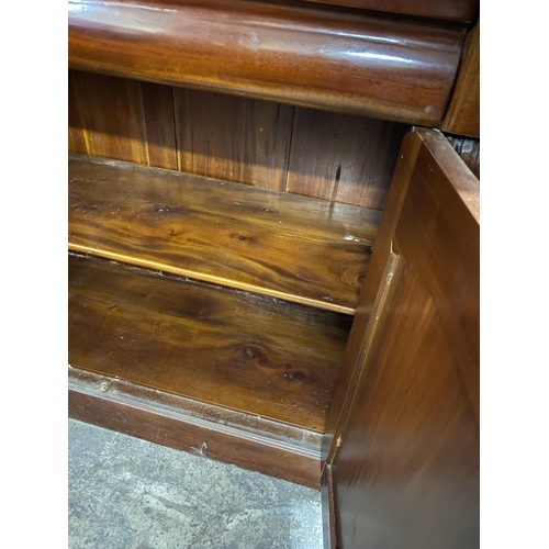 120 - A VICTORIAN MAHOGANY GLAZED BOOKCASE, with cornice above arched glass panelled doors, with carving t... 