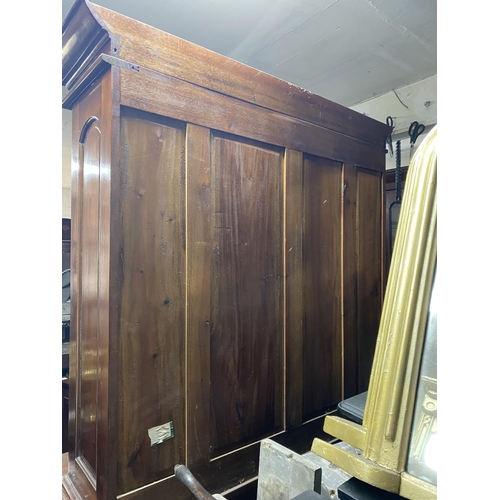 120 - A VICTORIAN MAHOGANY GLAZED BOOKCASE, with cornice above arched glass panelled doors, with carving t... 