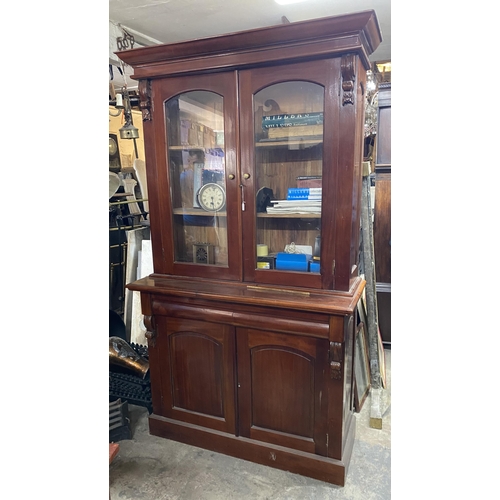 120 - A VICTORIAN MAHOGANY GLAZED BOOKCASE, with cornice above arched glass panelled doors, with carving t... 