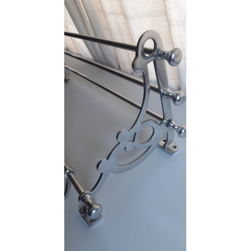 133 - A PULLMAN LUGGAGE RACK, with scrolling open work to the side supports and a series of hooks to the b... 