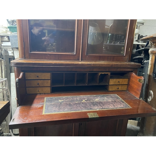 150 - A VICTORIAN MAHOGANY SECRETAIRE, with cornice above arched glass panelled doors, opening to shelved ... 