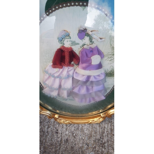 165 - A GILT FRAMED CONVEX GLASS DIORAMA, depicting a pair of ladies in Victorian fashion. Nice decorative... 