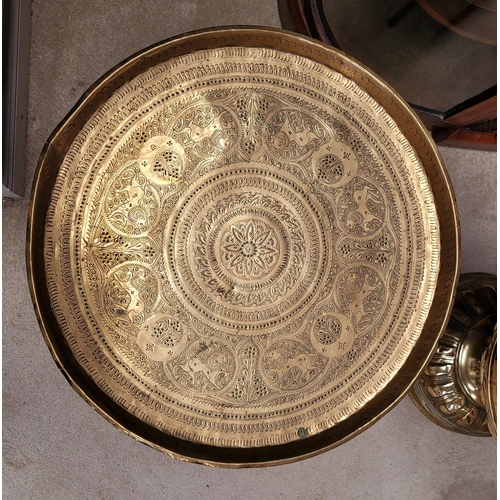 178 - AN INDIAN BRASS TRAY TABLE with folding turned wooden base, nice decorative antique piece, the tray ... 