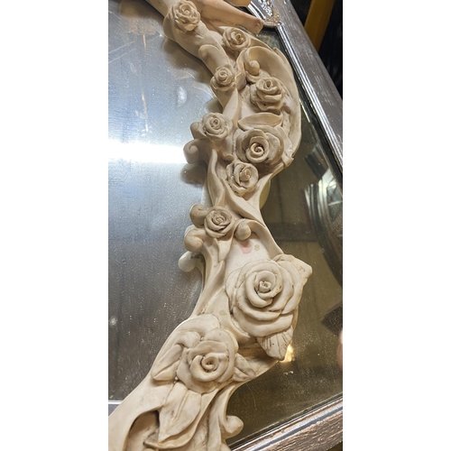 182 - A BEAUTIFUL ALABASTER CHERUB WALL MIRROR, crest form with floral rose decoration throughout, scroll ... 