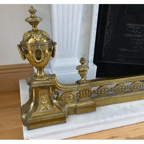 185 - AN ADJUSTABLE DECORATIVE FIRE FENDER with raised urn style ends, highly decorative with scrolling fo... 