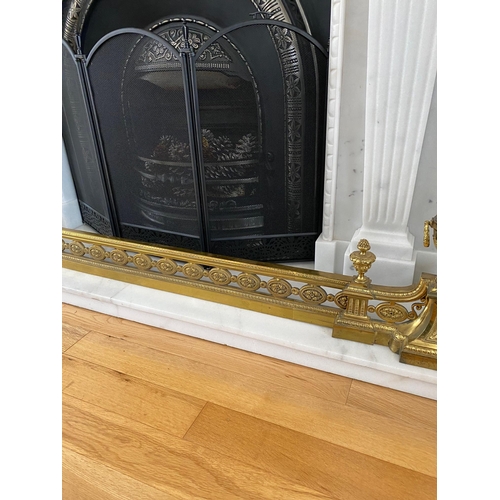 185 - AN ADJUSTABLE DECORATIVE FIRE FENDER with raised urn style ends, highly decorative with scrolling fo... 