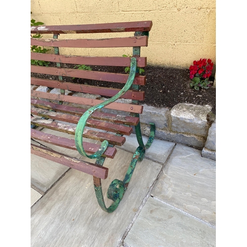 202 - A GOOD QUALITY VINTAGE WROUGHT IRON GARDEN BENCH WITH WOODEN SLATED SEAT AND BACK REST, the frame wi... 