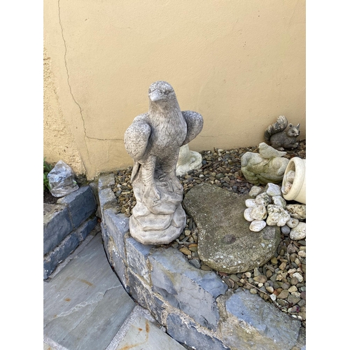 204 - A PAIR OF GARDEN STONE ORNAMENTS IN THE FORM OF TWO EAGLES, each standing upon a rock style base. 60... 