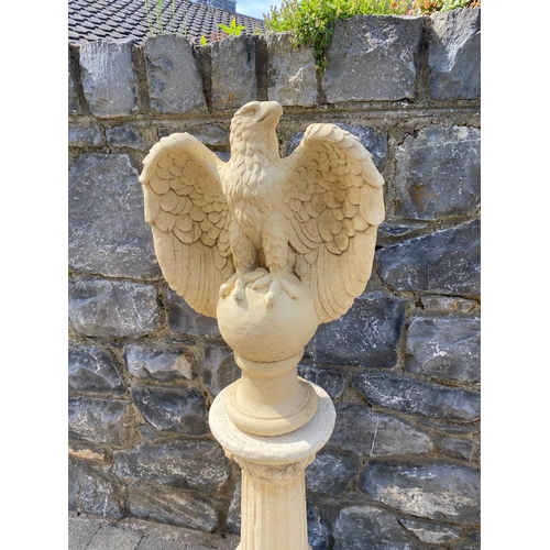 205 - A VERY GOOD PAIR OF STONE GARDEN ORNAMENTS IN THE FORM OF EAGLES, each standing on a ball with their... 