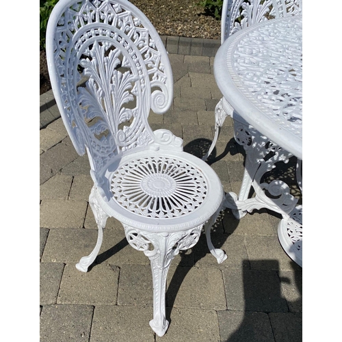 210 - A GOOD QUALITY CAST ALLOY GARDEN SUITE; including a circular table with scrolling legs having a circ... 