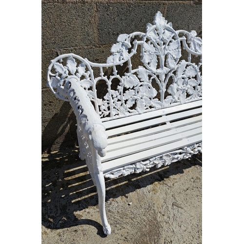 239 - A VERY GOOD QUALITY CAST IRON GARDEN BENCH, decorated with scrolling oak leaf decoration to the shap... 