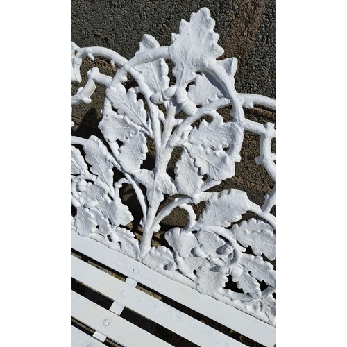 239 - A VERY GOOD QUALITY CAST IRON GARDEN BENCH, decorated with scrolling oak leaf decoration to the shap... 