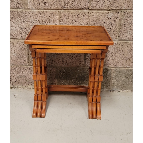 29 - A GOOD EARLY 20TH CENTURY NEST OF THREE YEW WOOD TABLES, each with a slightly raised edge to the tab... 