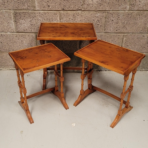 29 - A GOOD EARLY 20TH CENTURY NEST OF THREE YEW WOOD TABLES, each with a slightly raised edge to the tab... 