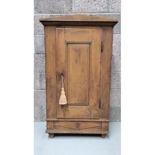 42 - A VERY CHAMING COUNTRY-STYLE / RUSTIC SINGLE DOOR CABINET, with a triangular pediment to the front, ... 