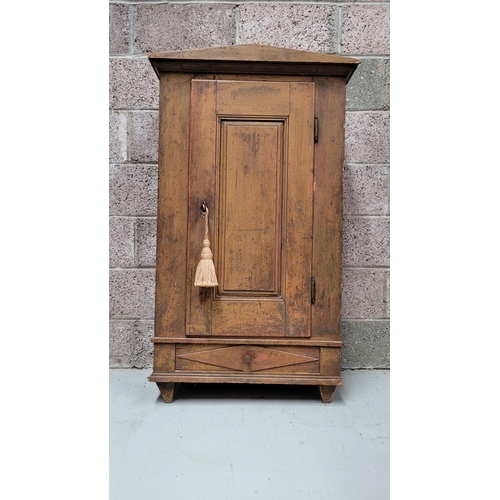 42 - A VERY CHAMING COUNTRY-STYLE / RUSTIC SINGLE DOOR CABINET, with a triangular pediment to the front, ... 