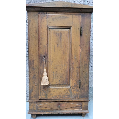 42 - A VERY CHAMING COUNTRY-STYLE / RUSTIC SINGLE DOOR CABINET, with a triangular pediment to the front, ... 