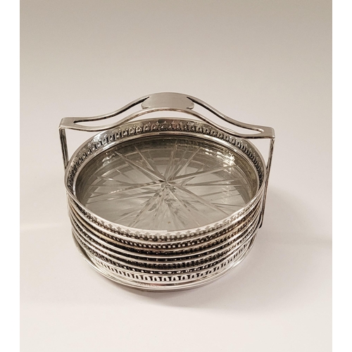 47 - AN EARLY 20TH CENTURY STERLING SILVER & GLASS COASTER CADDY, each of the 7 coasters have a raised pi... 