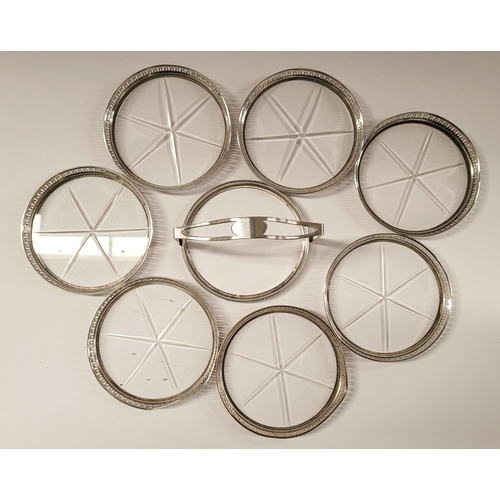 47 - AN EARLY 20TH CENTURY STERLING SILVER & GLASS COASTER CADDY, each of the 7 coasters have a raised pi... 