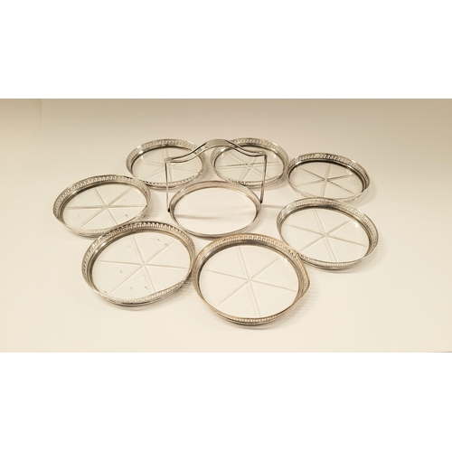 47 - AN EARLY 20TH CENTURY STERLING SILVER & GLASS COASTER CADDY, each of the 7 coasters have a raised pi... 