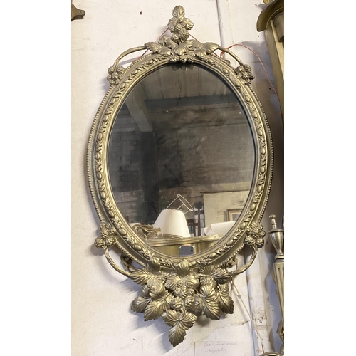 51 - A DEOCRATIVE 19TH CENTURY GILT OVAL WALL MIRROR, the frame highly decorated with attractive patterne... 