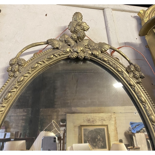 51 - A DEOCRATIVE 19TH CENTURY GILT OVAL WALL MIRROR, the frame highly decorated with attractive patterne... 