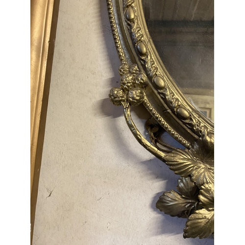 51 - A DEOCRATIVE 19TH CENTURY GILT OVAL WALL MIRROR, the frame highly decorated with attractive patterne... 