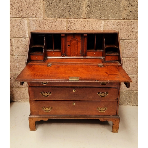 59 - AN OAK DROP FRONT SECRETAIRE DESK, four graduated drawers each with brass swing handles, raised on b... 