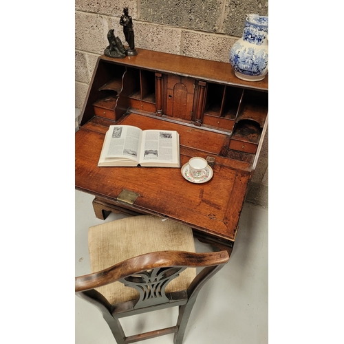 59 - AN OAK DROP FRONT SECRETAIRE DESK, four graduated drawers each with brass swing handles, raised on b... 