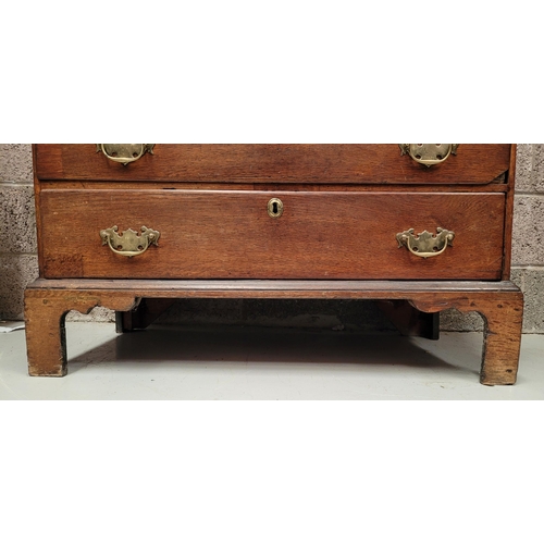 59 - AN OAK DROP FRONT SECRETAIRE DESK, four graduated drawers each with brass swing handles, raised on b... 