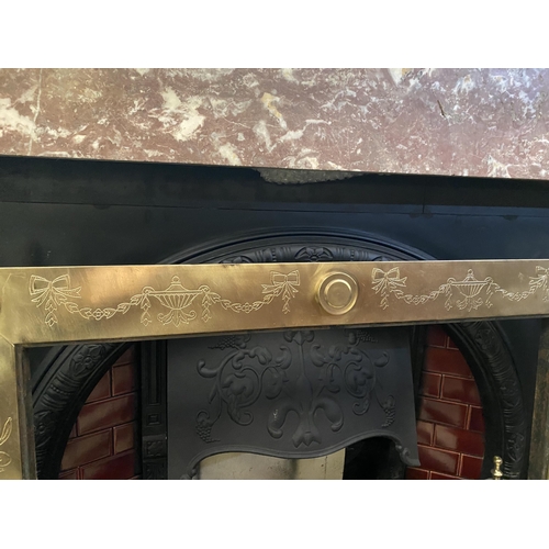 70 - AN EXCELLENT POLISHED BRASS FIRE INSERT, with decorative bow and swag designs throughout, finials to... 