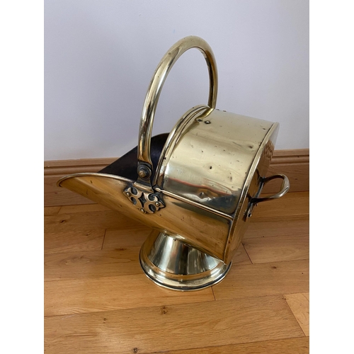 72 - A GOOD QUALITY POLISHED BRASS VICTORIAN HELMET SHAPED COAL SCUTTLE, with a curved handle to the top ... 