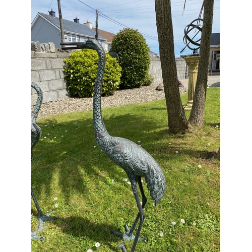 93 - A GOOD QUALITY PAIR OF GARDEN ORNAMENTS IN THE FORM OF STANDING HERON BIRDS, one standing tall, the ... 