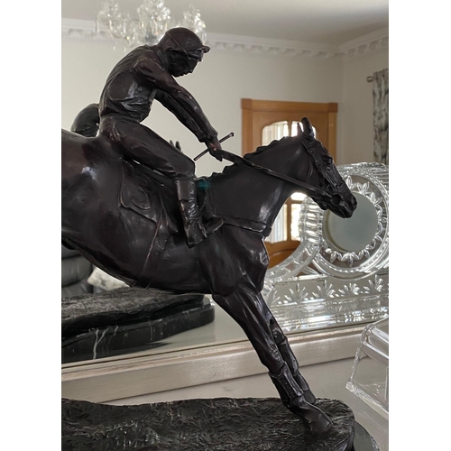 95 - A GREAT PAIR OF MANTEL ORNAMENTS IN THE FORM OF RACE HORSES WITH JOCKEYS, each of the horses set in ... 