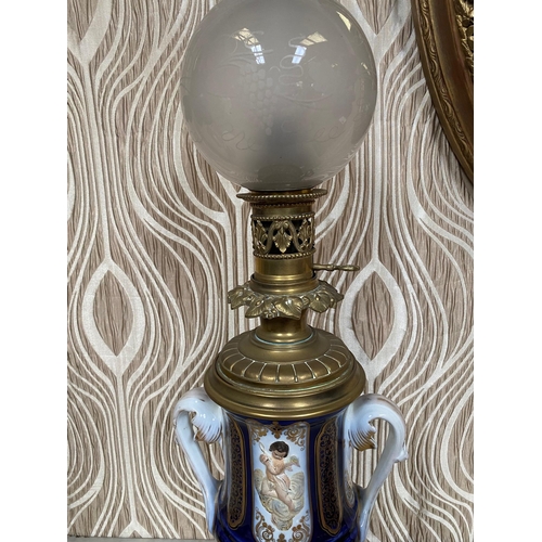 99 - A BEAUTIFUL PAIR OF SEVRES STYLE PORCELAIN & BRASS OIL LAMPS, each with a cobalt blue & gilt coloure... 