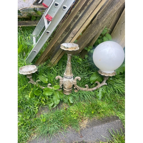 229 - AN ANTIQUE PAIR OF CAST IRON GARDEN LAMPS, each with double head fitting, the graduated column comes... 