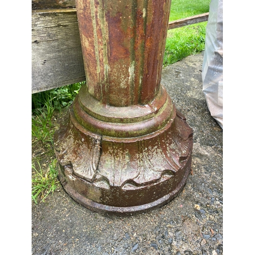 229 - AN ANTIQUE PAIR OF CAST IRON GARDEN LAMPS, each with double head fitting, the graduated column comes... 