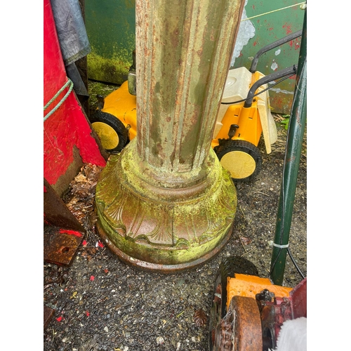 229 - AN ANTIQUE PAIR OF CAST IRON GARDEN LAMPS, each with double head fitting, the graduated column comes... 