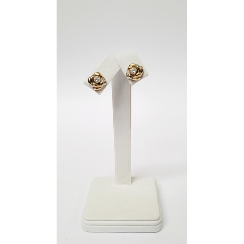 128 - A PAIR OF 9CT DUAL TONED GOLD STUD EARRINGS, with a central solitaire clear gemstone setting, marked... 