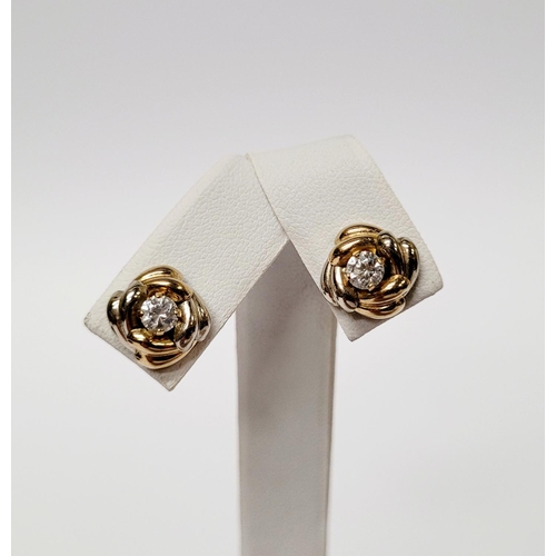 128 - A PAIR OF 9CT DUAL TONED GOLD STUD EARRINGS, with a central solitaire clear gemstone setting, marked... 