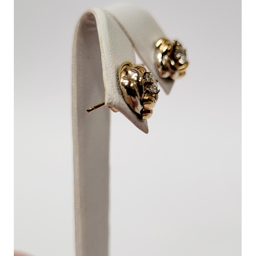128 - A PAIR OF 9CT DUAL TONED GOLD STUD EARRINGS, with a central solitaire clear gemstone setting, marked... 