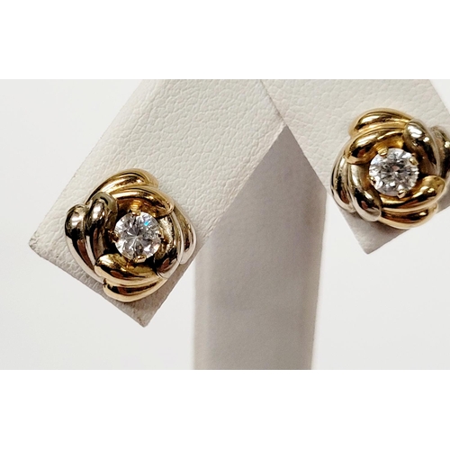 128 - A PAIR OF 9CT DUAL TONED GOLD STUD EARRINGS, with a central solitaire clear gemstone setting, marked... 
